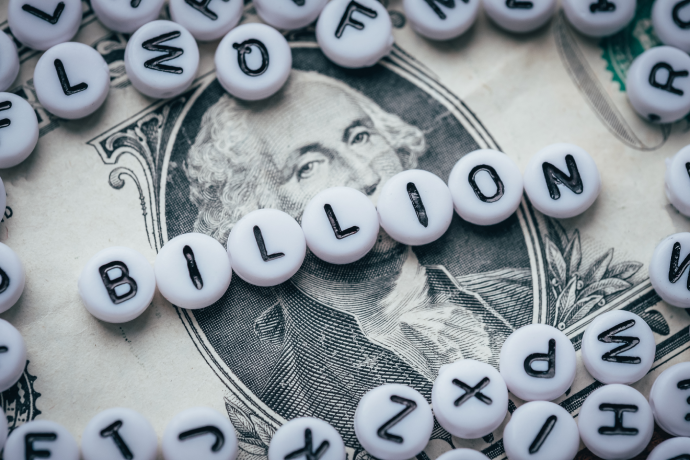 Word BILLION made from small white letters on dollar background