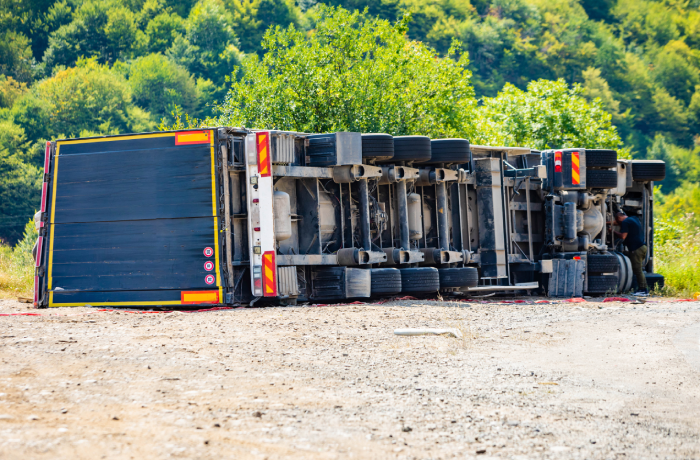 Large cargo truck turned over on road traffic accident at day
