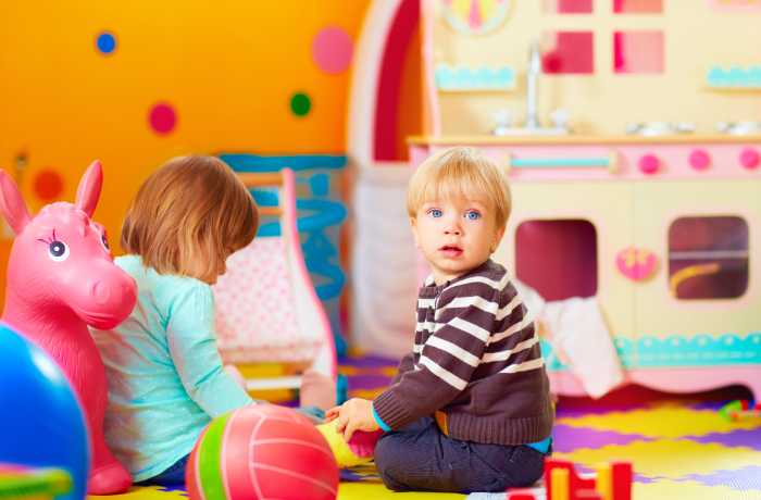 cute little kids playing together in daycare center